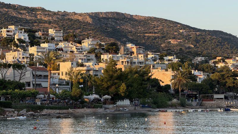 Hillside town reflected in a calm bay
