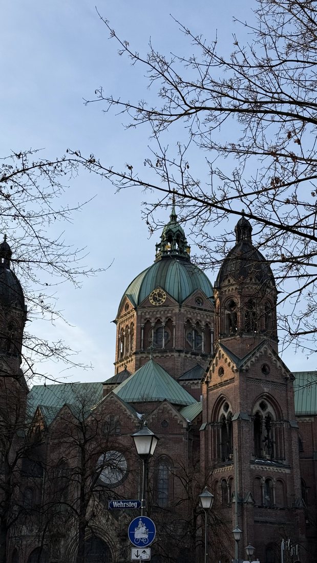 Green-domed church framed by bare branches